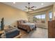 Bedroom featuring a large window, ceiling fan, and wood-look floors, creating a serene and bright atmosphere at 12839 W Rincon Ct, Sun City West, AZ 85375