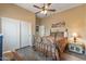 Comfortable bedroom featuring sliding closet doors, a ceiling fan, and wood-look floors ensuring a relaxed and stylish atmosphere at 12839 W Rincon Ct, Sun City West, AZ 85375