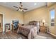 Bedroom features stylish decor, ceiling fan, and wood-look floors creating a modern, comfortable space at 12839 W Rincon Ct, Sun City West, AZ 85375