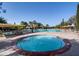 Relaxing community pool area featuring a hot tub, lounge chairs, and shaded cabanas, perfect for leisure at 12839 W Rincon Ct, Sun City West, AZ 85375