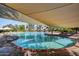 Large community pool with ample lounge chairs and shade canopies offers a resort-style experience at 12839 W Rincon Ct, Sun City West, AZ 85375