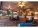 Expansive covered patio with multiple seating areas, ceiling fans, and seamless transition to indoor living spaces at 12839 W Rincon Ct, Sun City West, AZ 85375