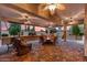 Inviting covered patio features ample seating, ceiling fans, and views of a serene desert landscape at 12839 W Rincon Ct, Sun City West, AZ 85375