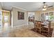 Elegant dining room with tile flooring, chair railing, and an open view of the living room at 12839 W Rincon Ct, Sun City West, AZ 85375