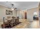 A dining room with a rustic table, chairs, and access to another room at 12839 W Rincon Ct, Sun City West, AZ 85375