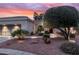 Landscaped yard with stone and desert plants leading to a single-story home with a two-car garage at 12839 W Rincon Ct, Sun City West, AZ 85375