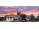 Charming single-story home with a landscaped front yard and a two-car garage at dusk at 12839 W Rincon Ct, Sun City West, AZ 85375