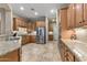 Spacious kitchen featuring granite counters, stainless steel appliances, and wood cabinetry at 12839 W Rincon Ct, Sun City West, AZ 85375