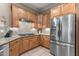 Kitchen featuring stainless steel appliances, granite countertops, and wooden cabinets, exuding style and functionality at 12839 W Rincon Ct, Sun City West, AZ 85375