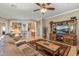 Open-concept living room with a large television and views into the kitchen at 12839 W Rincon Ct, Sun City West, AZ 85375