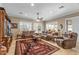 Spacious living room featuring comfortable sofas, neutral colors, and window shutters at 12839 W Rincon Ct, Sun City West, AZ 85375
