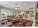 Inviting living room with plush seating, a decorative rug, and seamless flow to the kitchen at 12839 W Rincon Ct, Sun City West, AZ 85375