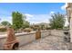 Relaxing outdoor patio with brick pavers, potted flowers and privacy wall for backyard enjoyment at 12839 W Rincon Ct, Sun City West, AZ 85375