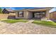 Exterior of a house with a landscaped backyard and artificial turf at 14372 W Aster Dr, Surprise, AZ 85379