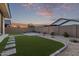 Large backyard with artificial turf, pavers, gravel and desert landscaping at 14372 W Aster Dr, Surprise, AZ 85379