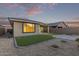 Beautiful backyard with artificial turf, decorative rock, and a paver path at 14372 W Aster Dr, Surprise, AZ 85379