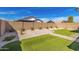 Well-maintained backyard features artificial turf, pavers, and desert landscaping at 14372 W Aster Dr, Surprise, AZ 85379