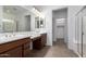 Bathroom featuring a dual sink vanity, tiled flooring and a walk-in closet access at 14372 W Aster Dr, Surprise, AZ 85379