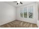 Bright bedroom with carpet, ceiling fan, and three windows providing natural light at 14372 W Aster Dr, Surprise, AZ 85379