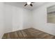 Bedroom featuring a ceiling fan, neutral carpet, and a window with blinds at 14372 W Aster Dr, Surprise, AZ 85379