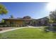 Charming community clubhouse surrounded by green lawns and walking paths at 14372 W Aster Dr, Surprise, AZ 85379
