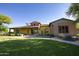 Community clubhouse with colorful exterior, inviting landscaping, and ample parking at 14372 W Aster Dr, Surprise, AZ 85379