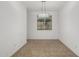 Dining room with tile flooring, a modern light fixture, and a window at 14372 W Aster Dr, Surprise, AZ 85379