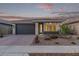 Charming single-story home featuring a two-car garage, low maintenance desert landscaping, and a welcoming front entrance at 14372 W Aster Dr, Surprise, AZ 85379