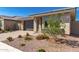 Gorgeous single-story home featuring a two-car garage, desert landscaping, and a beautifully kept front yard at 14372 W Aster Dr, Surprise, AZ 85379