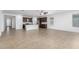 Spacious living room showcasing an open concept design that seamlessly connects to the well-appointed kitchen at 14372 W Aster Dr, Surprise, AZ 85379