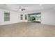 Bright living room featuring a ceiling fan, large sliding glass doors and tile flooring at 14372 W Aster Dr, Surprise, AZ 85379