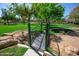 Serene park view with a bridge and nearby playground, providing a scenic and engaging environment for families at 14372 W Aster Dr, Surprise, AZ 85379