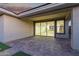 Covered patio area with brick pavers, exterior lighting, and access to the house at 14372 W Aster Dr, Surprise, AZ 85379