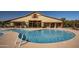 Community pool featuring crystal-clear water, lounge seating, and convenient restroom and shower facilities at 14372 W Aster Dr, Surprise, AZ 85379