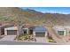 Modern home with desert landscaping and mountain views featuring glass garage door and stylish facade at 14455 N Adero Canyon Dr, Fountain Hills, AZ 85268