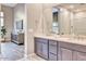 Modern bathroom featuring double sinks, wooden cabinets, and an open view of the bedroom at 14455 N Adero Canyon Dr, Fountain Hills, AZ 85268