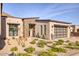 Stunning exterior view of a modern home with desert landscaping and a three car garage at 14455 N Adero Canyon Dr, Fountain Hills, AZ 85268