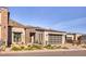 Contemporary single-Gathering house featuring a glass garage door, xeriscaping, and mountain backdrop at 14455 N Adero Canyon Dr, Fountain Hills, AZ 85268