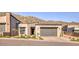 Modern home with a sleek glass garage door, desert landscaping, and mountain views at 14455 N Adero Canyon Dr, Fountain Hills, AZ 85268