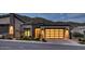 Contemporary-style home features a modern garage door, desert landscaping, and well-lit facade at 14455 N Adero Canyon Dr, Fountain Hills, AZ 85268