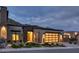 Contemporary-style home features a modern garage door, desert landscaping, and well-lit facade at 14455 N Adero Canyon Dr, Fountain Hills, AZ 85268