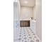 Practical laundry room with a star pattern floor, white appliances, and a sleek dark wood vanity at 14455 N Adero Canyon Dr, Fountain Hills, AZ 85268
