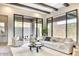 Bright living room with modern furniture, wooden beam ceiling, and large sliding glass doors at 14455 N Adero Canyon Dr, Fountain Hills, AZ 85268