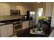 Well-equipped kitchen featuring stainless steel appliances and dark countertops at 14462 N Sherwood Dr # B, Fountain Hills, AZ 85268