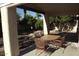 Covered outdoor patio includes a metal table and chairs, overlooking a garden space at 14462 N Sherwood Dr # B, Fountain Hills, AZ 85268