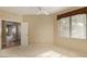 Spacious bedroom featuring a ceiling fan, neutral walls and carpet, and a large window at 15252 N 100Th St # 1151, Scottsdale, AZ 85260
