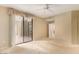 Airy bedroom with large glass door, ceiling fan, and access to outdoor space at 15252 N 100Th St # 1151, Scottsdale, AZ 85260
