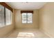 Neutral bedroom with large windows, light carpet, and decorative window treatments at 15252 N 100Th St # 1151, Scottsdale, AZ 85260