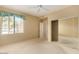 Bright bedroom featuring a sliding closet door, ceiling fan, and a large window at 15252 N 100Th St # 1151, Scottsdale, AZ 85260