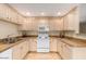 Traditional kitchen featuring granite counters, light wood cabinets, and white appliances at 15252 N 100Th St # 1151, Scottsdale, AZ 85260